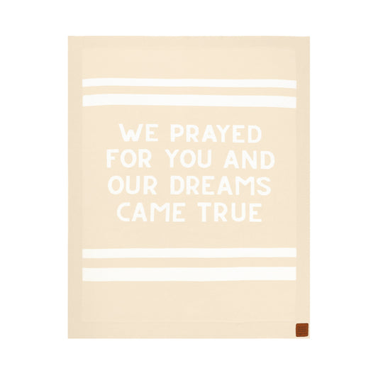 Beige knit baby blanket with white text 'WE PRAYED FOR YOU AND OUR DREAMS CAME TRUE', a Christian newborn gift
