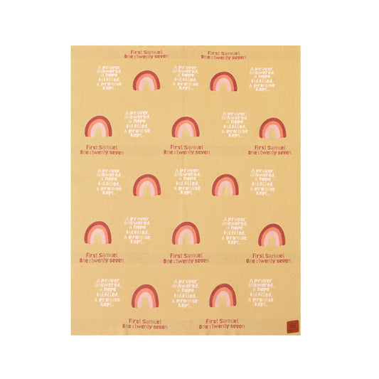 Close-up of Christian baby blanket with pink and red rainbows and "1 Samuel 1:27" scripture pattern on cotton.